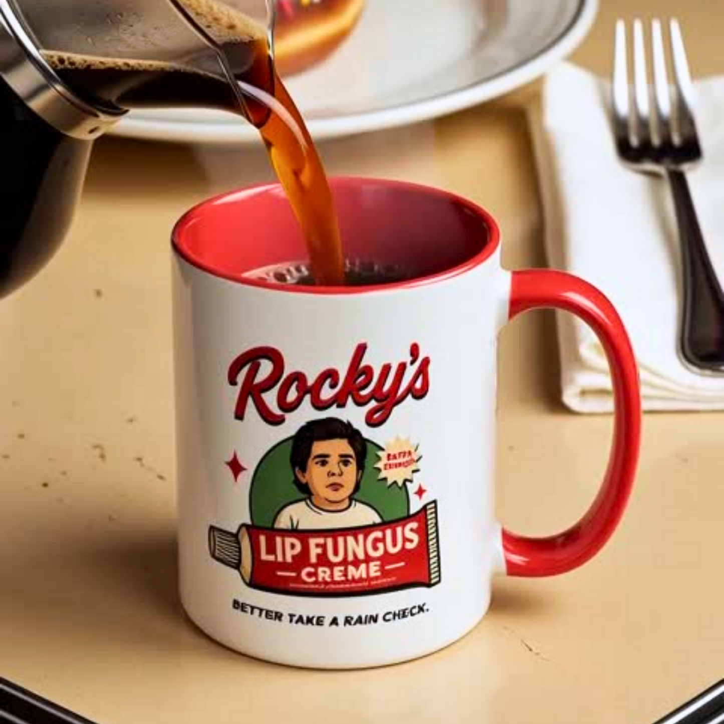 Coffee being poured into a mug with 'Rocky's Lip Fungus Creme' branding on a table.
